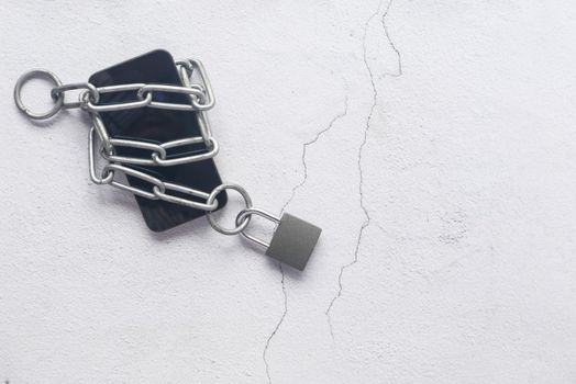 Smart Phone With Padlock And Chain Over White Background