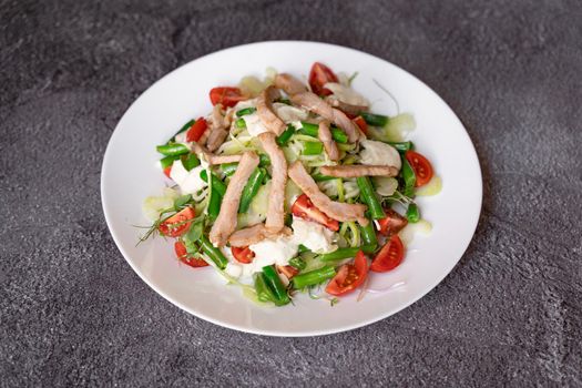 Caesar salad with chicken and parmesan, cherry tomato, lettuce, croutons and egg.