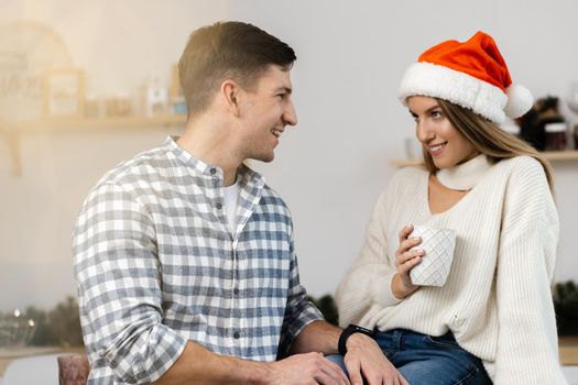 Young festive couple spending time togather in room, close up
