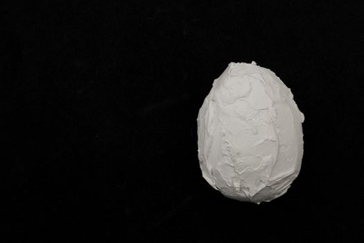 Stone egg on a dark background.