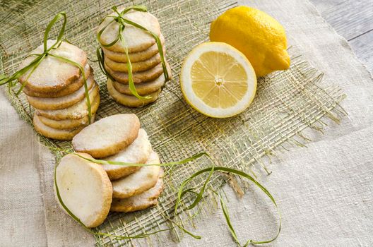 Homemade lemon sugar cookies tied up with rope on linen tablecloth From series Winter pastry