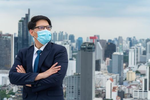 Young office worker with face mask quarantine from coronavirus or COVID-19. Concept of protective working environment to reopen business and stop spreading of coronavirus or COVID-19.