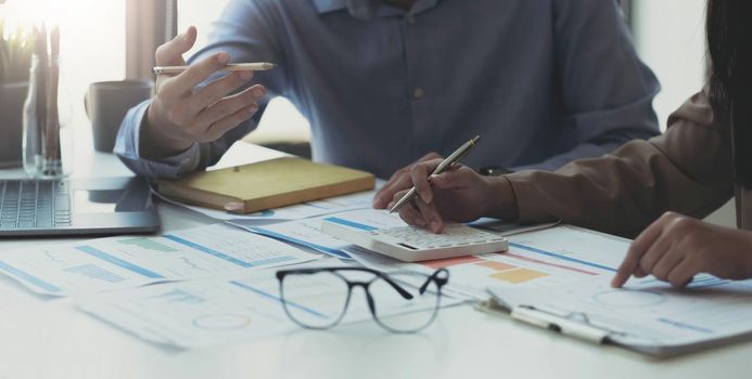 Two business partnership coworkers analysis strategy with discussing a financial planning graph and company budget during a budget meeting in office room..