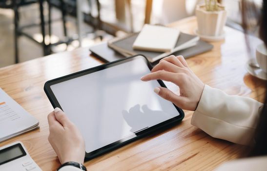 Businesswoman using laptop blank screen while working with calculator for financial. Clipping path.