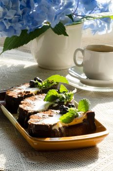 Chocolate cake with mint and blueberries on rectangular plate. From series "Chocolate cake"