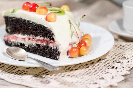 Bird-cherry flour cake with cherries, strawberries and kiwi. Homemade cake. From series "bird-cherry cake"