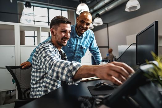 Two young men working together on a new business project in office, close up