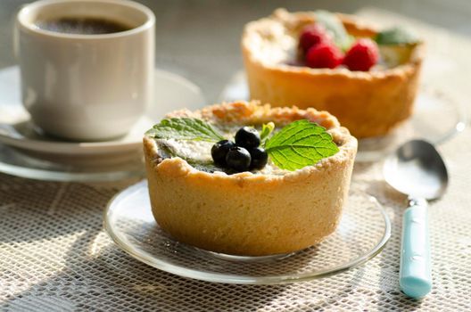 Mini berry tarts decorated with raspberries and blueberries