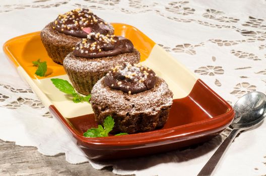 Diet chocolate cupcakes on a plate decorated with chocolate. From the series "Recipes for diet Ducane"