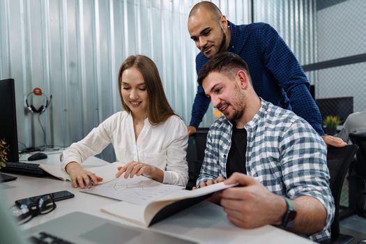 Group of young business people working in office together