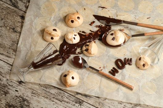 Funny meringue with chocolate on baking paper. From series Fun food