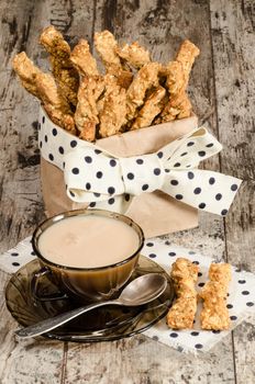 Garlic cheese bread sticks and cup of black tea with milk From series Homemade bread