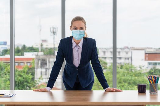 Office worker with face mask quarantine from coronavirus or COVID-19. Concept of protective working environment to reopen business and stop spreading of coronavirus or COVID-19.