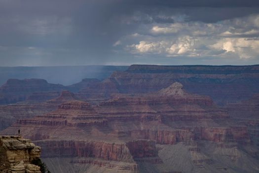 Landscape showing Gran Canyon with a person over a cliff in Arizona USA