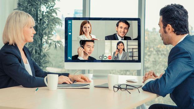 Video call group business people meeting on virtual workplace or remote office. Telework conference call using smart video technology to communicate colleague in professional corporate business.