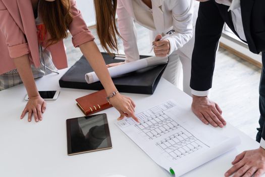 Architect and engineer working with construction drawing project on table in office. Architecture and engineering business concept.