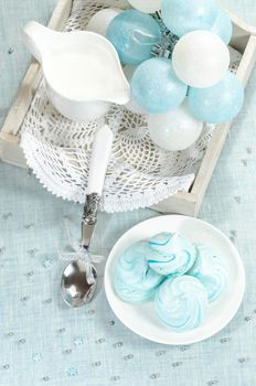 Christmas decorations, azure homemade meringue cookies and cup of milk From series Christmas and New Year