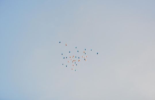 Multicolored air helium balloons in the clear blue cloudless sky