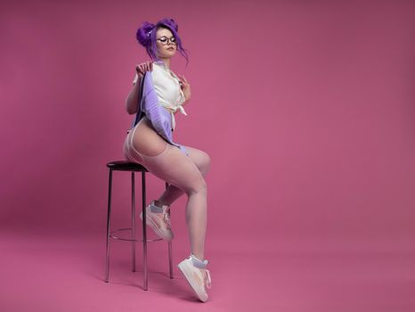 the sexy schoolgirl girl with purple hair in summer short clothes and beautiful underwear on a pink background