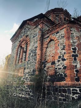 Ancient building of church with smooth black and brown bricks.