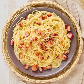 Close up carbonara pasta. Spaghetti with bacon, egg, parmesan cheese and cream sauce. Top view. Traditional italian cuisine.