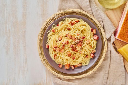 Carbonara pasta. Spaghetti with bacon, egg, parmesan cheese and cream sauce. Top view, copy space. Traditional italian cuisine.