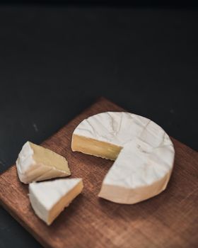 cheese camembert with mold on the wooden cutting board