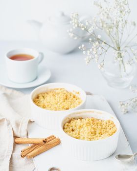 Apple crumble with streusel on light gray table. Morning breakfast.