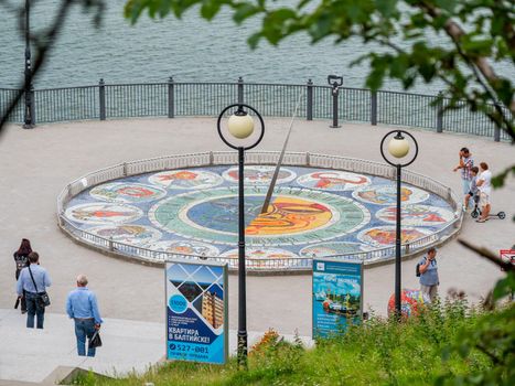 SVETLOGORSK, RUSSIA - July 21, 2019. Tourists near mosaic sun clocks Zodiak by Nikolay Frolov, art landmark of sea embankment of Svetlogorsk.
