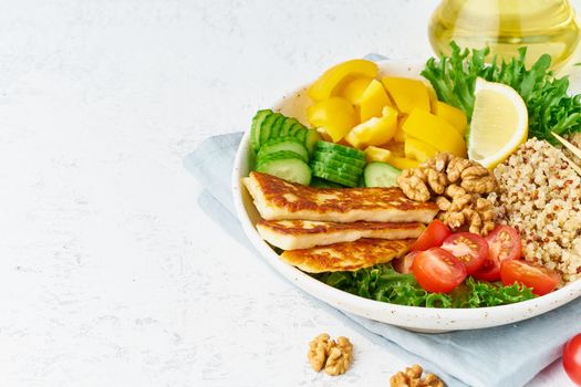 Buddha bowl with halloumi, quinoa, salad lettuce, vegetarian menu, white background, closeup with copy space