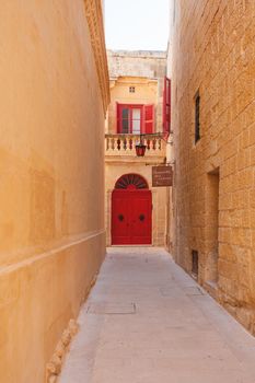 MDINA, MALTA - February 18, 2010. Narrow streets of Mdina, old capital of Malta. Stone buildings with old fashioned doors and balconies.