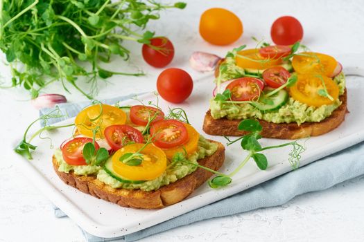 avocado toast with cherry tomatoes and herbs, breakfast, closeup