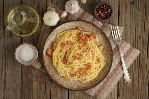 Carbonara pasta. Spaghetti with bacon, egg, parmesan cheese. Traditional italian cuisine. Top view