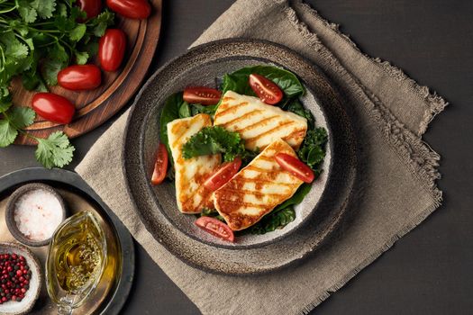 Cyprus fried halloumi cheese with healthy green salad and tomatoes. Lchf, pegan, fodmap, paleo, scd, keto, ketogenic diet. Balanced food, a greek clean eating recipe.
