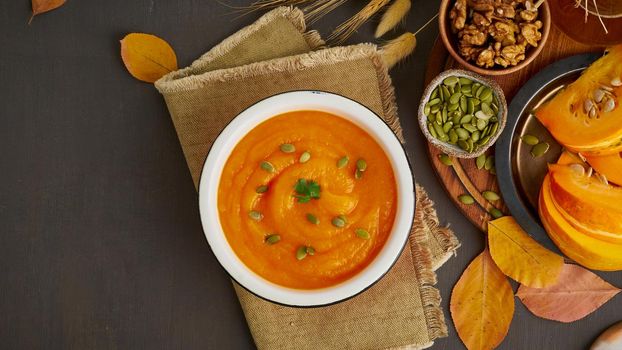 healthy and diet creamy soup with pumpkin seeds and nuts, copy space