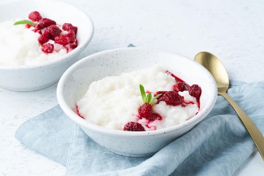 Rice pudding, side view. Healthy Vegan diet breakfast with a coconut milk, raspberry, scandinavian minimalism
