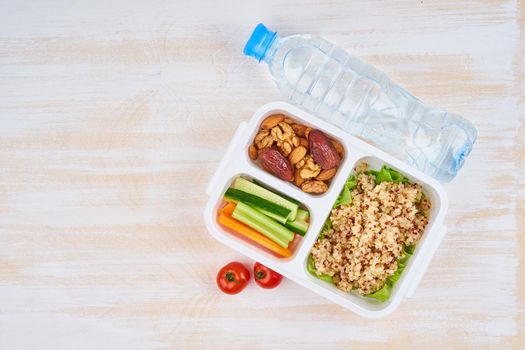 Vegan lunch box, water in bottle, copy space. Healthy vegetarian menu, weight loss, healthy lifestyle
