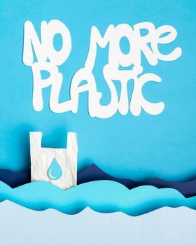 top view paper ocean waves with plastic bag message