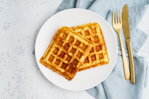 Chaffle, ketogenic diet health food. Homemade keto waffles with egg, mozzarella cheese. Gluten - free and carb-free. White background.