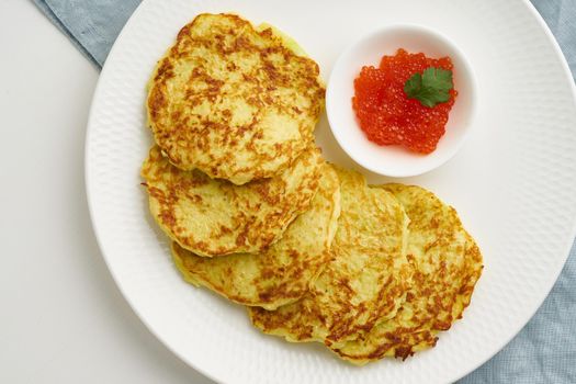 Balanced and gluten free zucchini pancakes with red caviar