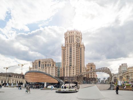 MOSCOW, RUSSIA - May 01, 2022. Local people and tourists walk on square near Paveletsky railway. Modern urban architecture.