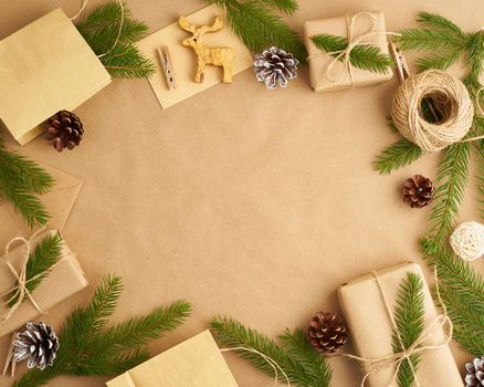 Christmas and Happy New Year zero waste craft paper background. Handmade gift Christmas box, fir branches, cup with a hot chocolad, marshmallows, top view, copy space. Hand crafted, plastic free
