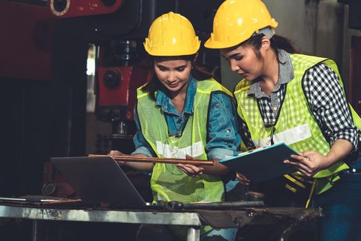 Factory job workers working and discussing manufacturing plan in the factory . Industry and engineering concept .