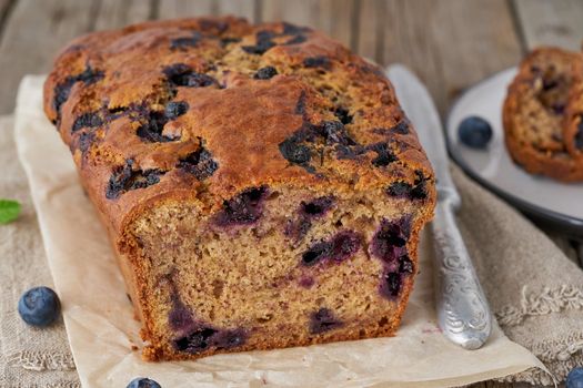 Banana bread on old wooden rustic table, slice of a cake with banana, side view