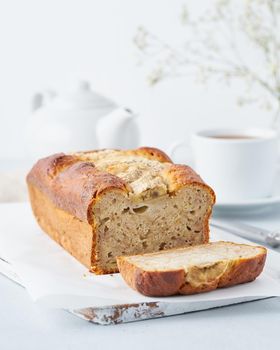 Banana bread, cake with banana, side view, vertical. The morning Breakfast on light grey background