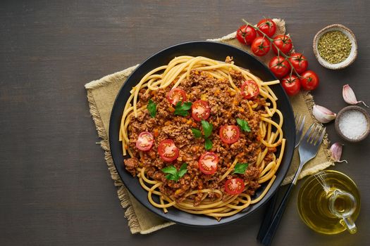 mediterranean pasta bolognese bucatini with mincemeat, tomatoes, carrot and basil leaves