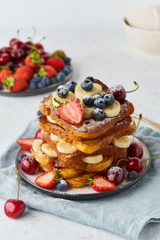 healthy french toasts with berries and banana, confort stack of toasts, homemade brioche