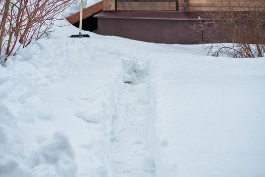 snowdrift in the center, tree in the corner and stairs in the top part of the photo