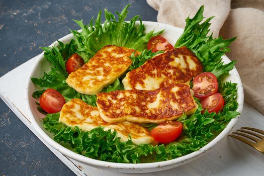 vegan salad with fried halloumi and tomatoes, closeup, keto ketogenic diet
