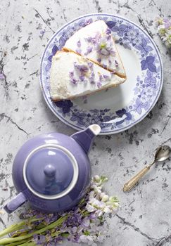 still life with black tea and cheese cake, spring bouquet of delicate lilac flowers, flatley food, High quality photo